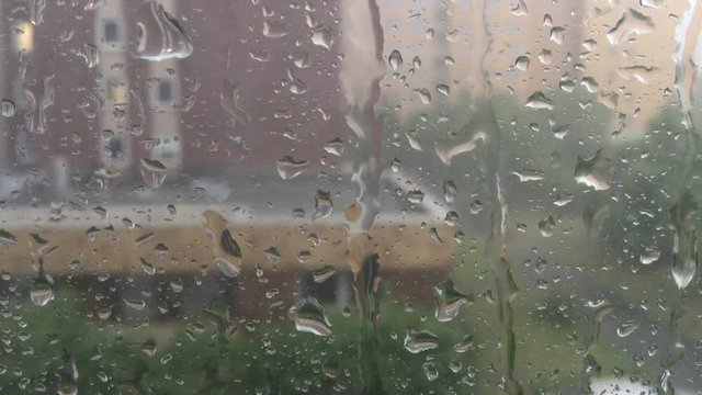 Raindrops on glass during the summer rain storm