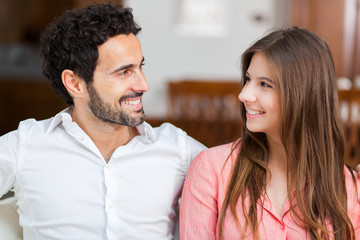 Young couple on the sofa in love