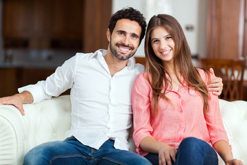 Young couple on the sofa in love