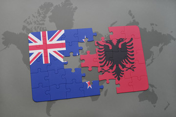 puzzle with the national flag of new zealand and albania on a world map background