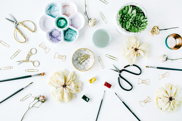 flat lay composition with bow tie clips, scissors, dry tulip, roses, palette, succulent on white background. top view