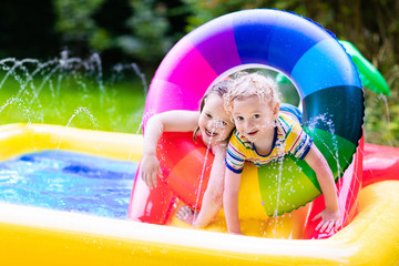 Kids playing in garden swimming pool