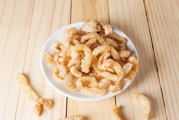 Pork rind junk food snack in white plate