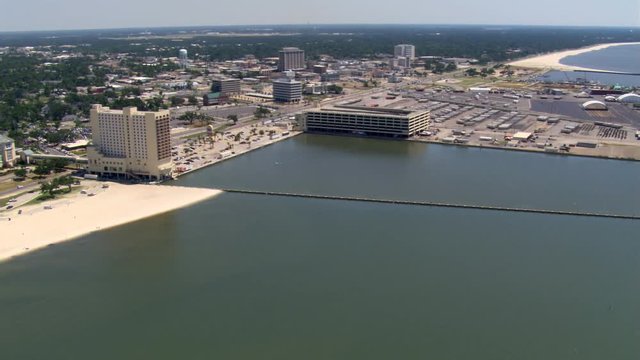 Flight along waterfront with wide view of Gulfport, Mississippi. Shot in 2007.
