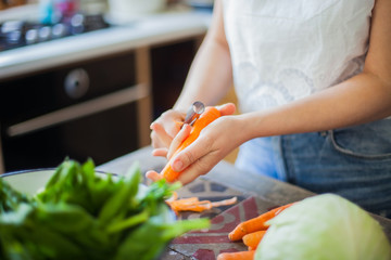 Woman cooking in kitchen with ingredients around her