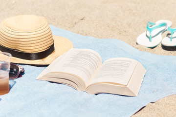 Beauty products for make a relaxed day on the beach with a book