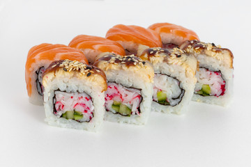 sushi rolls on a white background with salmon, avocado, caviar crab and sesame seeds