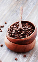 roasted coffee beans in wooden bowl, selective focus