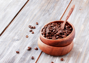 roasted coffee beans in wooden bowl, selective focus