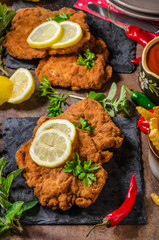 Schnitzel with fries, salad and herbs