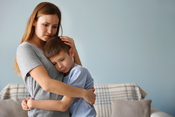 Family problems concept. Mother embracing son