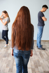 Naklejka premium Family problems concept. Girl looking on abusing parents