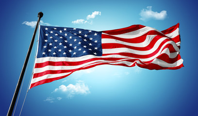 The national flag of the United states on blue sky with clouds