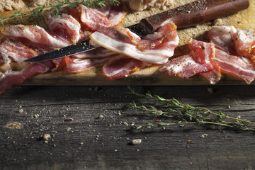 Smoked ham with rosemary on cutting board