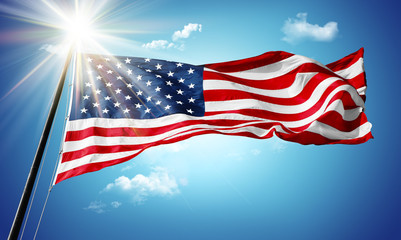 American flag in blue sky and sunshine background