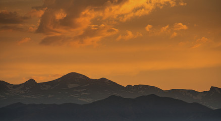 silhouette of mountains against sunset sky