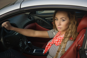 Fototapeta na wymiar Sensual fashionable woman in a car