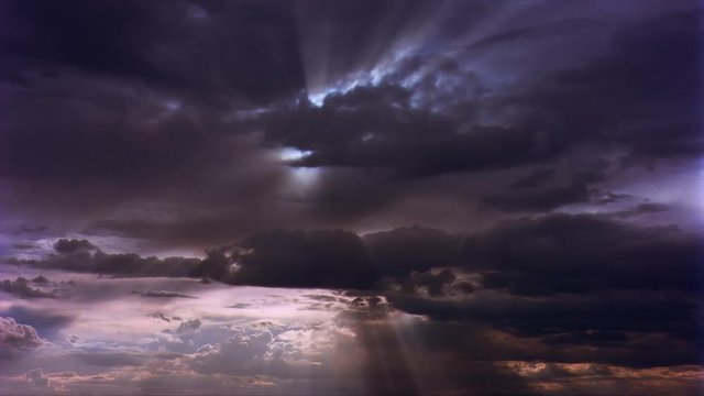 Time-lapse sunbeams shining through clouds