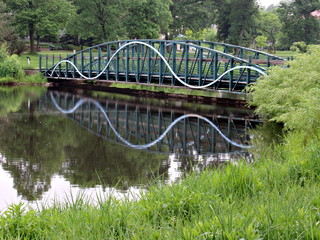 Footbridge Reflecting in Still Pond