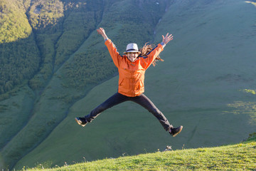 Girl jumping on hill