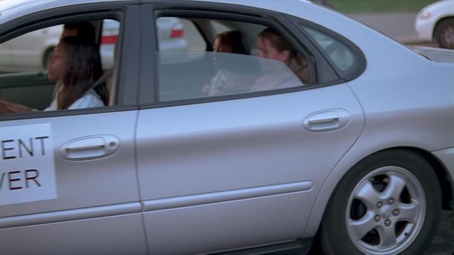 Driver's ed students and instructor beginning a behind-the-wheel lesson