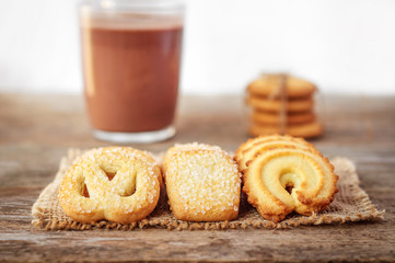  Butter cookies closeup  on Rustic Wooden Background with a cup
