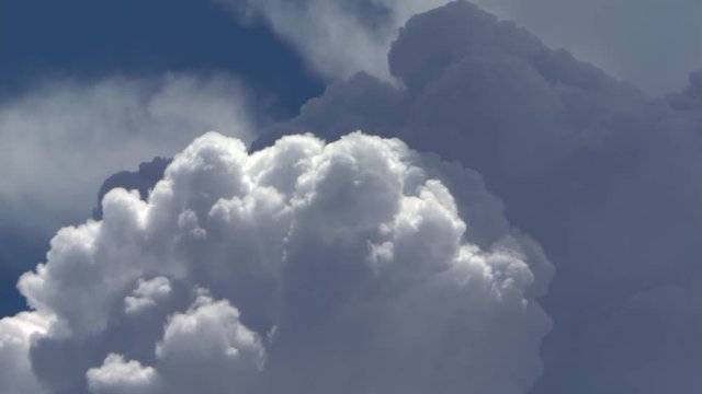 Tops of layered cumulus clouds billowing, time lapse