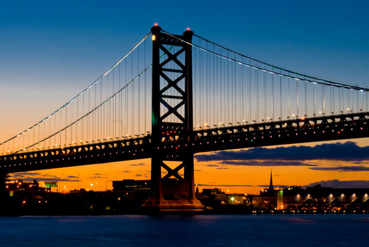 A Sunset View of  The Benjamin Franklin Bridge, Philadelphia, Pennsylvania from the Delaware River.
