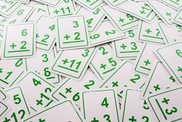 Education: Green addition math cards  randomly spread out on table. Educational school supplies.
Edicational background