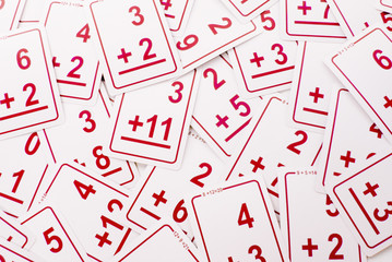 Education: Red addition math cards  randomly spread out on table. Educational school supplies.
Edicational background