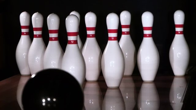 Ultra-slow motion shot of bowling ball knocking down all ten pins