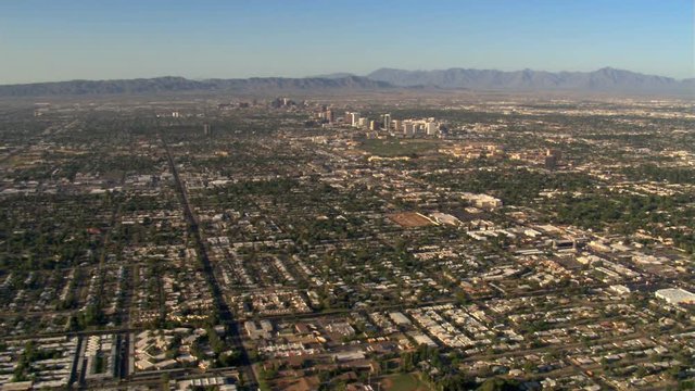 Wide approach toward downtown Phoenix over outlying areas. Shot in 2007.