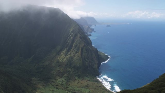 Over wooded hills to wide view of the Molokai coastline. Shot in 2010.