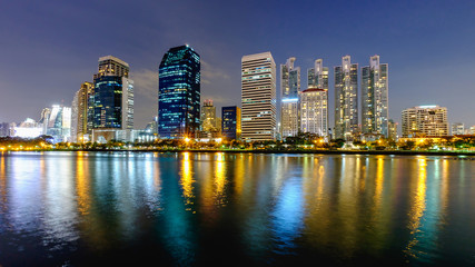 Fototapeta na wymiar Bangkok city downtown at night with reflection of skyline