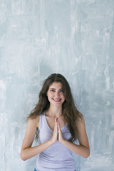 Fototapeta premium Happy woman with namaste hands smiling at camera