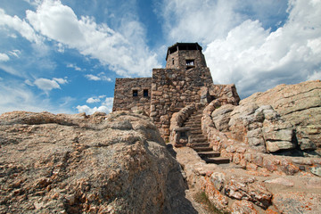 Harney Peak Fire Lookout Tower under cirrus and cumulus clouds in Custer State Park in the Black...