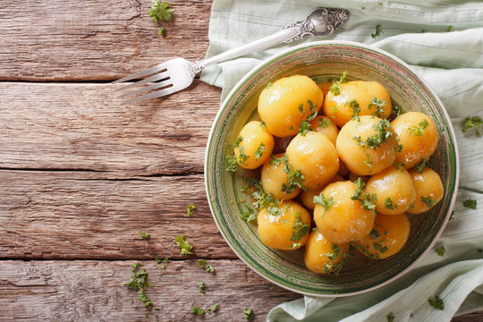 Glazed new potatoes with parsley close-up on the table. horizontal top view
- Powered by Adobe