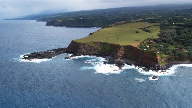 Orbiting green pastureland on sea cliffs along Maui's north shore. Shot in 2010.