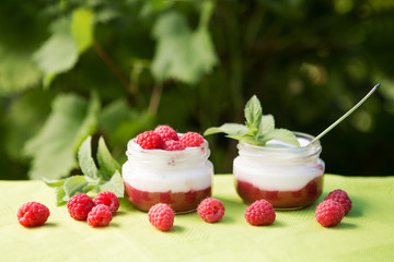 yogurt with fresh raspberry on wooden background. healthy morning breakfast.

