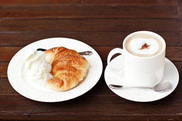 Fresh baked croissants with smug of cappuccino