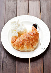 Fresh baked croissants with smug of cappuccino