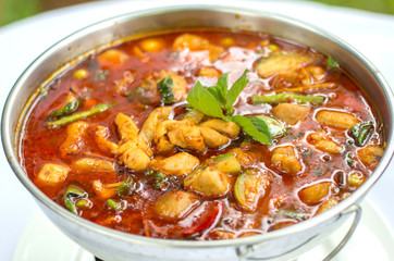 Jungle curry chicken in hot pot, Thai traditional food.