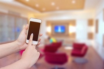 Woman hands holding and using smart phone with blurred of waitin
