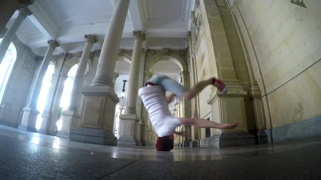Young breakdancer dancing on the street in Karlovy vary, Czech Republic