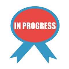IN PROGRESS white wording on background red ribbon