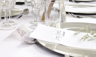 a table setting for a festive white wedding