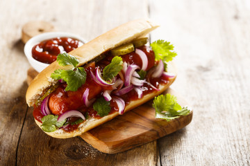 Hot dog with pickled cucumber and onion