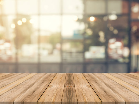 Wooden board empty table in front of blurred background. Perspective brown wood over blur in coffee shop - can be used for display or montage your products.Mock up for display of product.