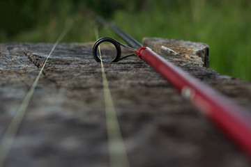 Obraz premium Fishing rod on wood