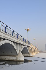 Bridge street lamp and the frozen river
